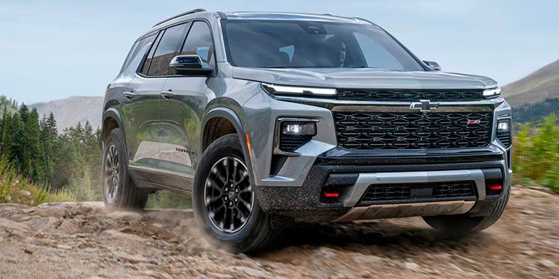 A silver suv driving off-road.