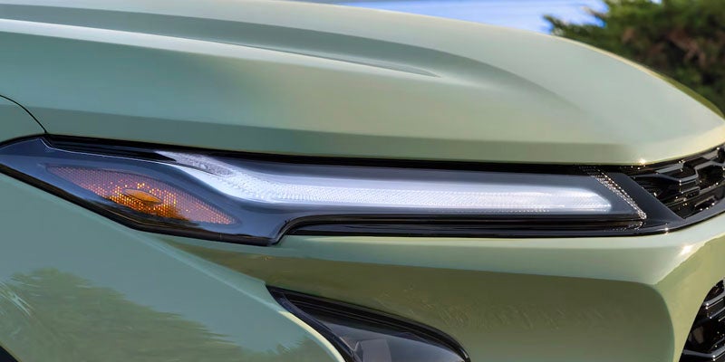 close up of the led headlights on a green chevy trax