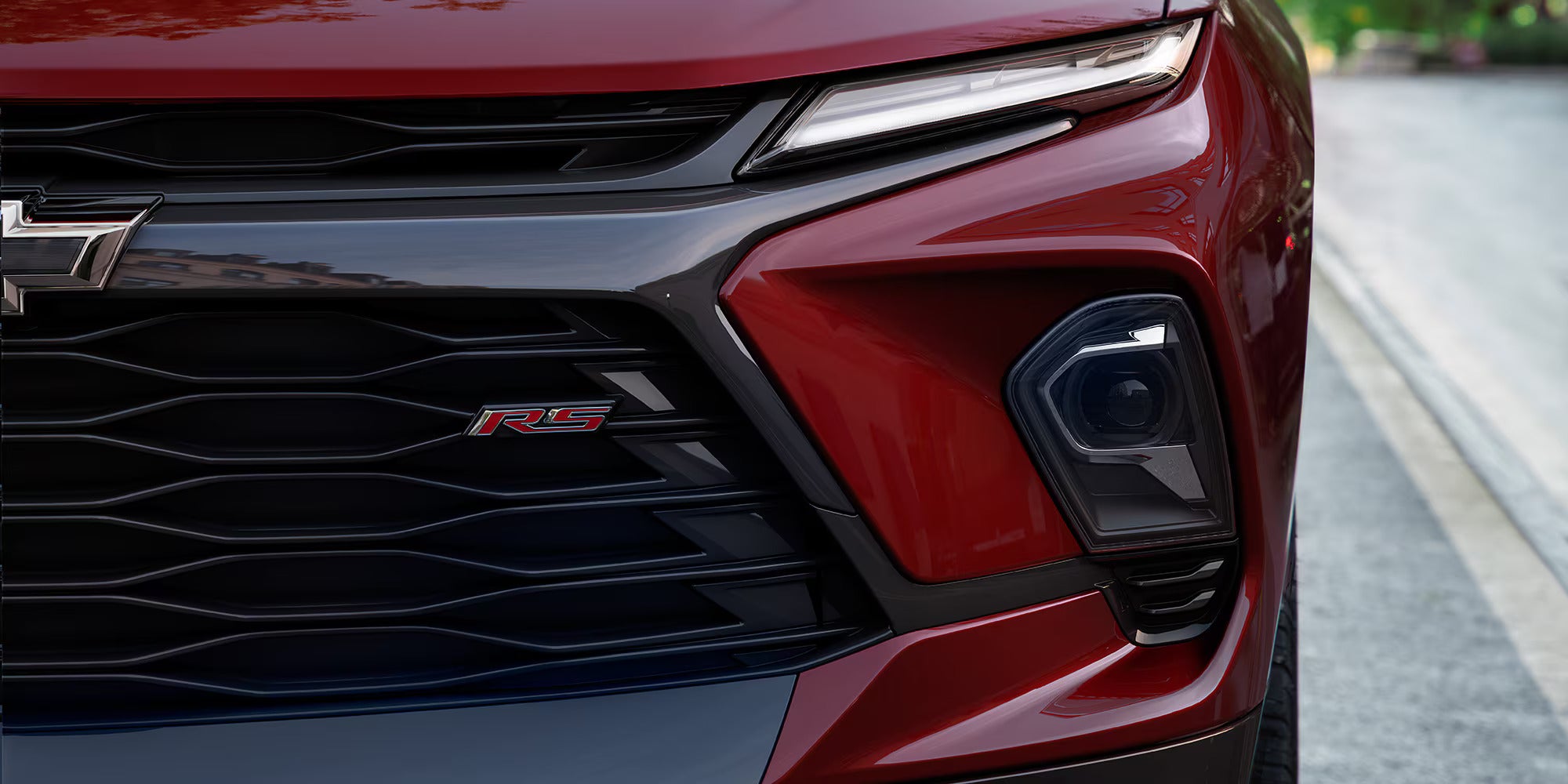 upclose view of RS badging and LED headlights on a red 2025 blazer
