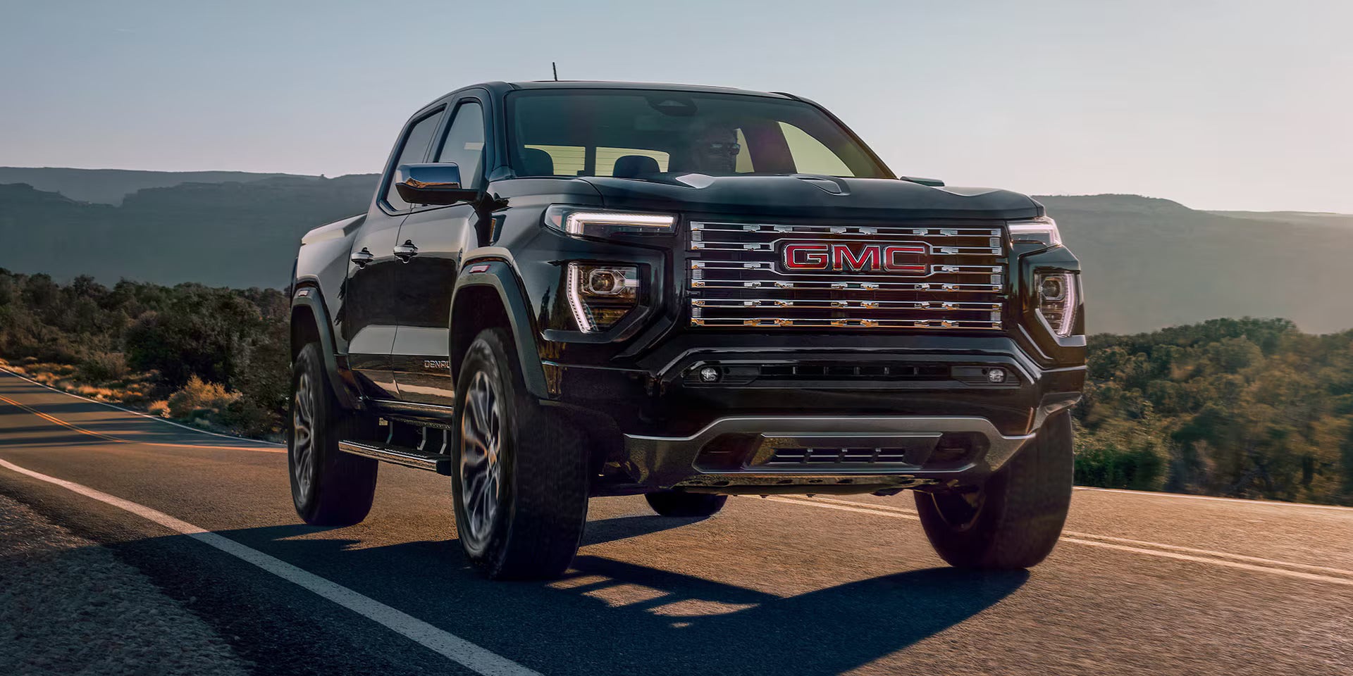 a 2025 gmc canyon parked on a dirt path in the desert