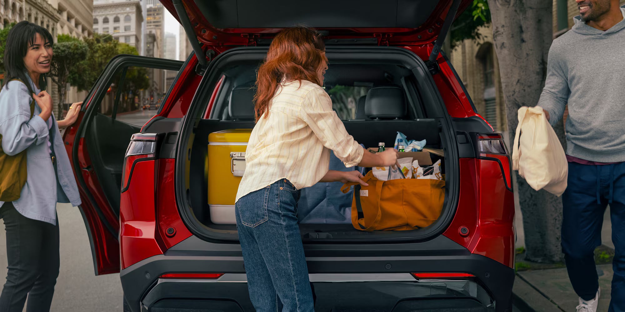 cargo area with a woman packing it in the chevy equinox