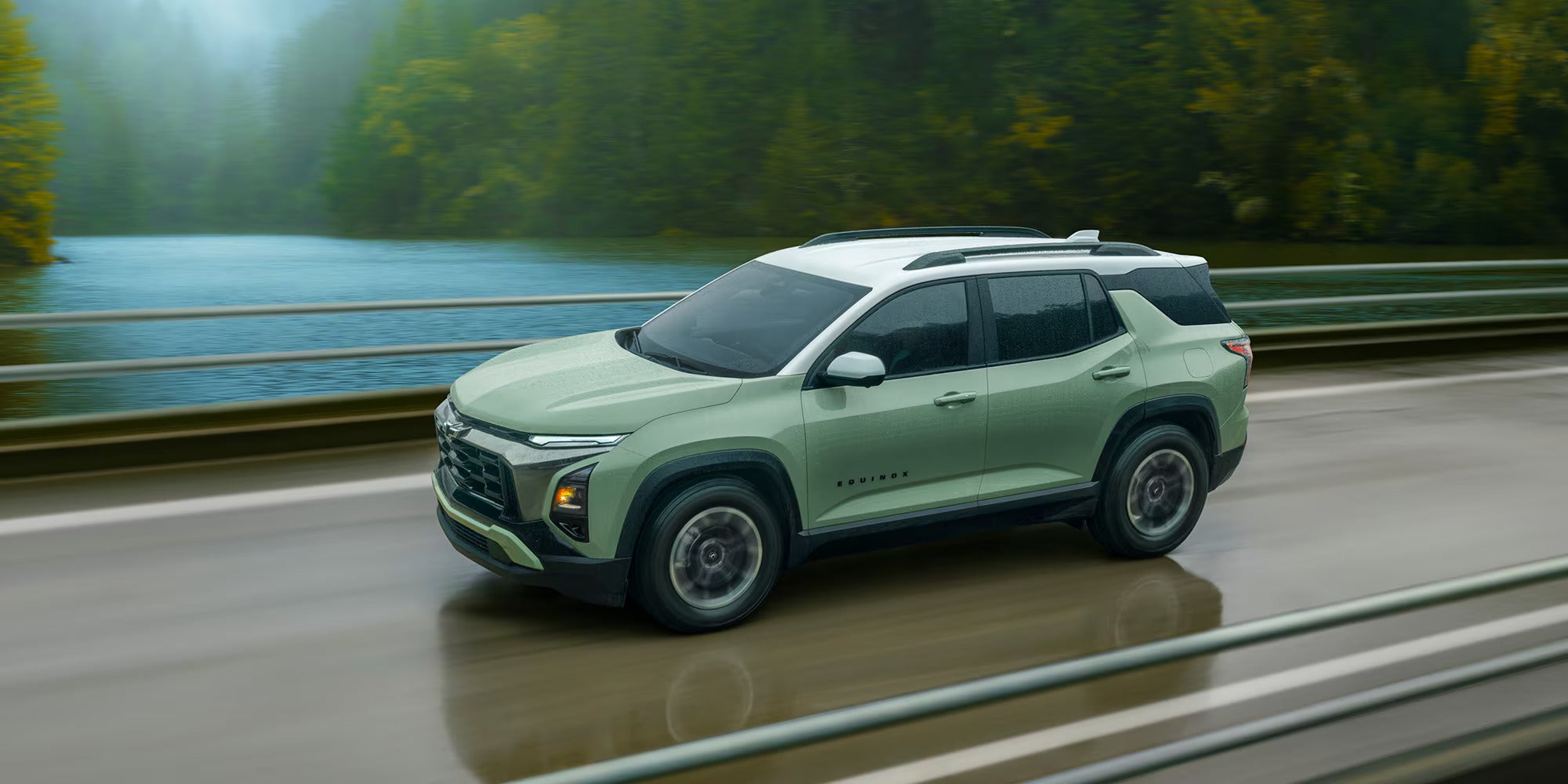 a green chevy equinox driving on the highway