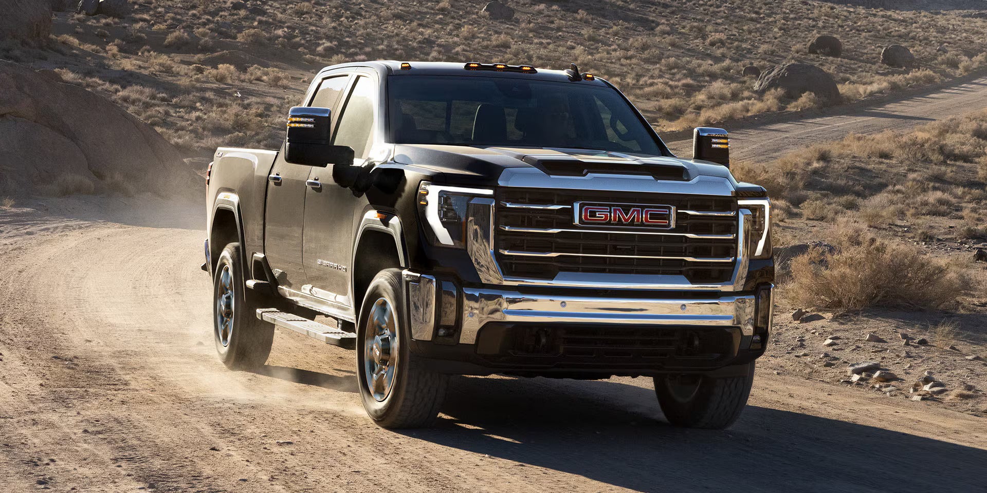 a 2025 gmc sierra hd parked with a horse trailer attached