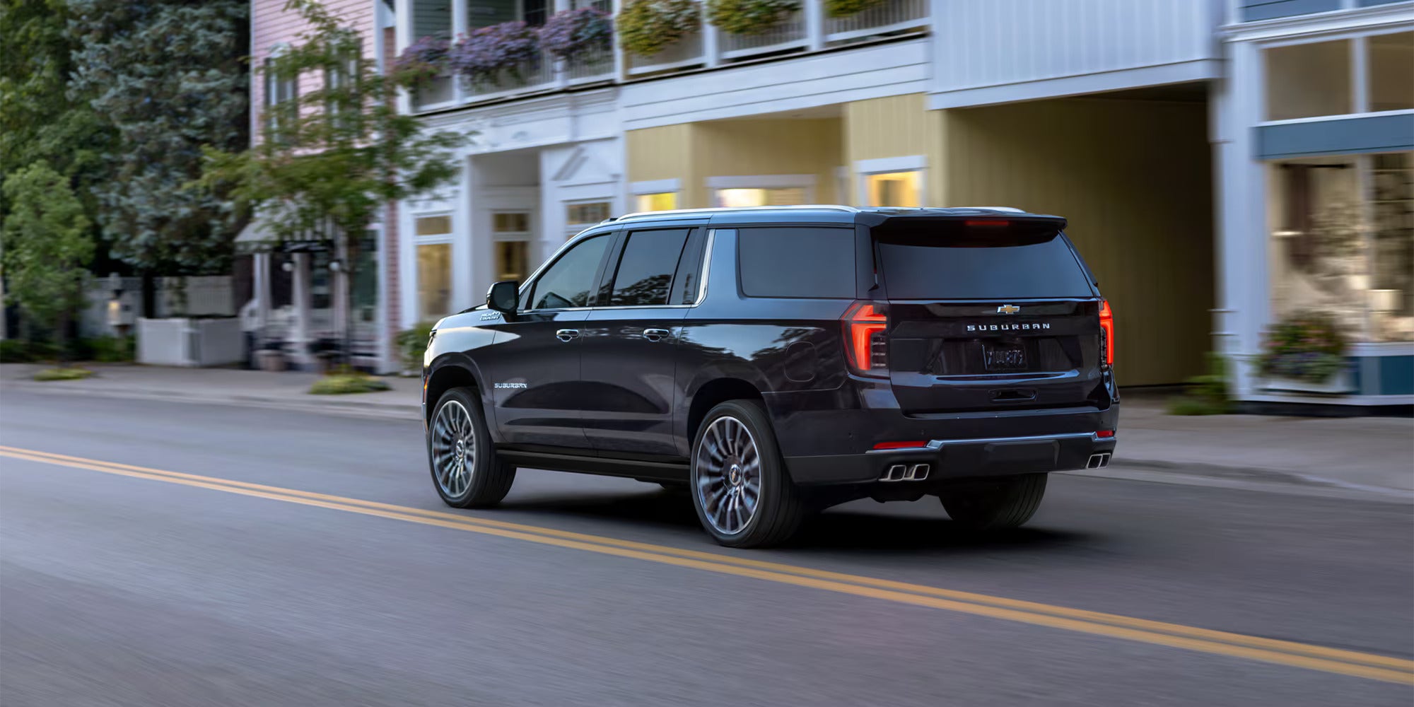 A black suv driving on the road.