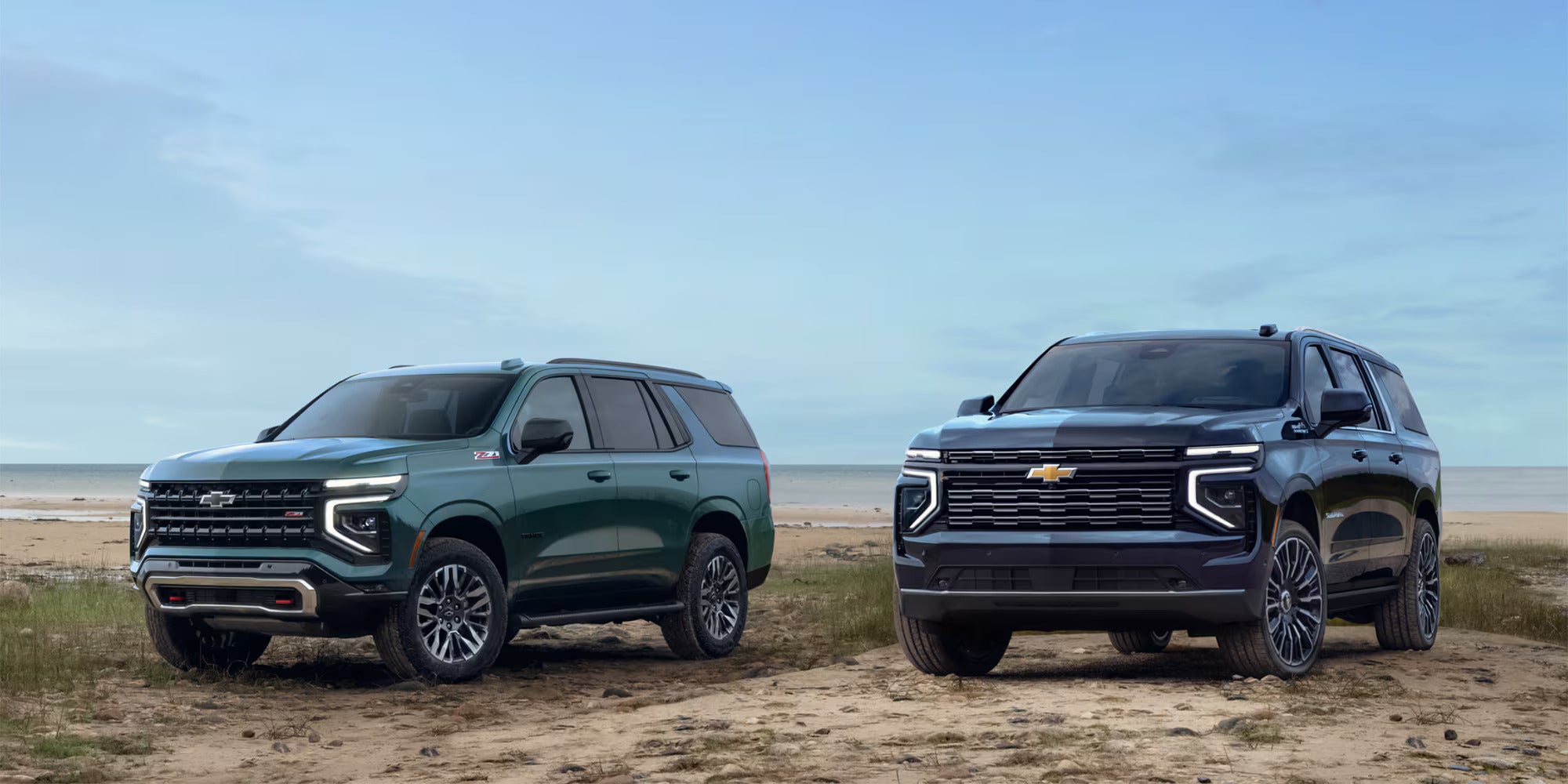 Two suvs sitting parked by eachother.