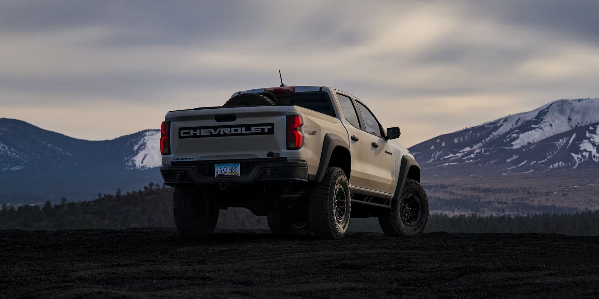 A white truck parked off-road.
