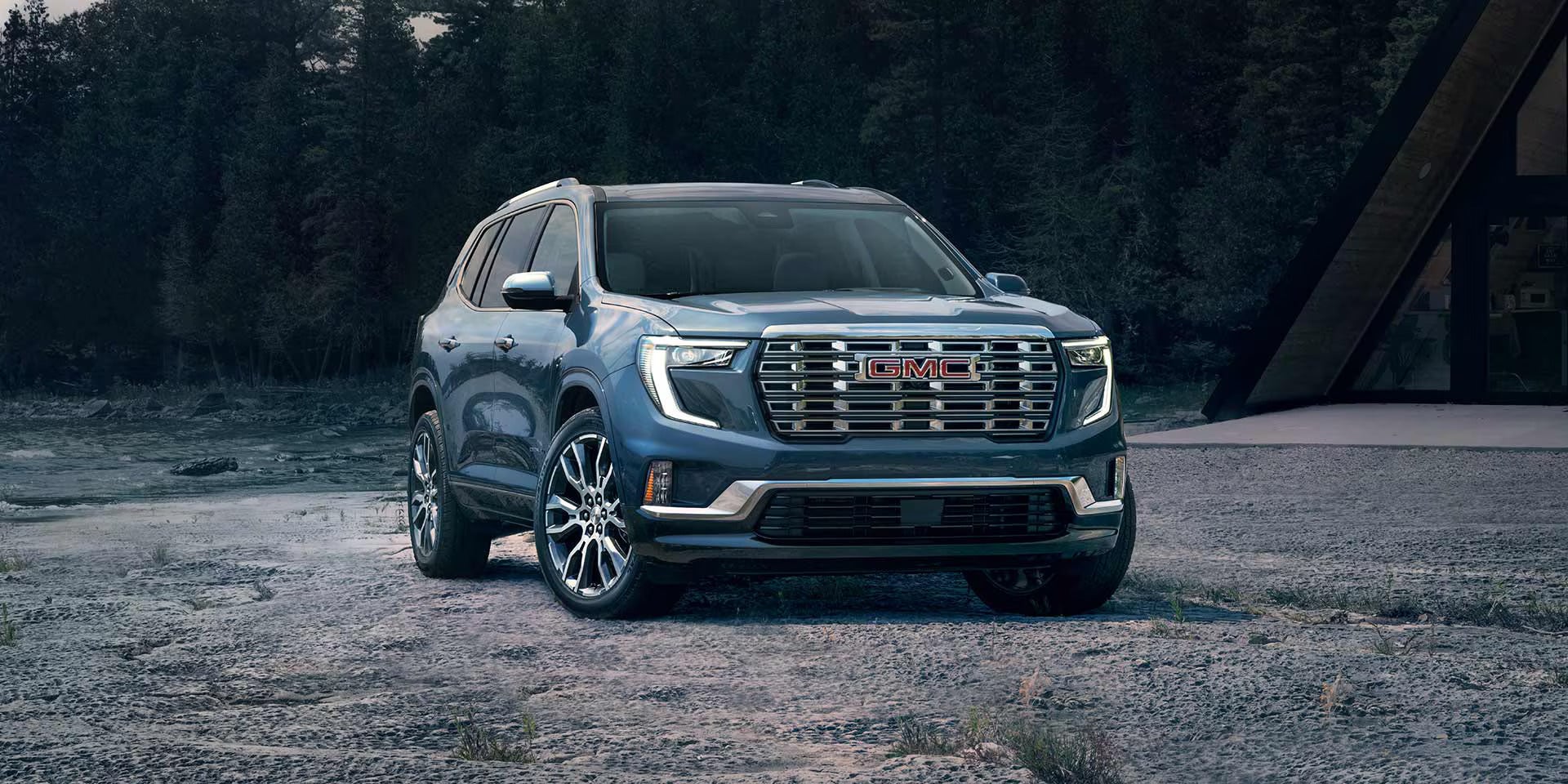 2026 gmc acadia parked on gravel near a cliff facing