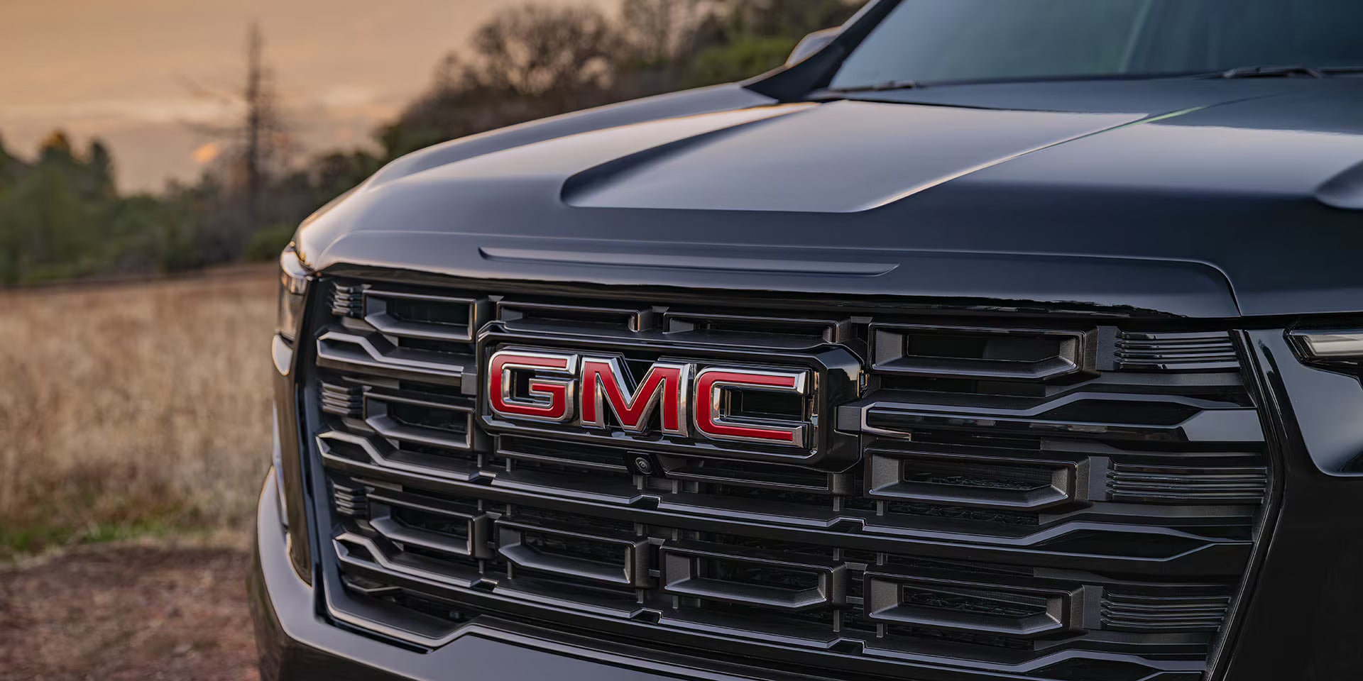up close look at the gmc emblem on the front grille of the 2026 bmc acadia