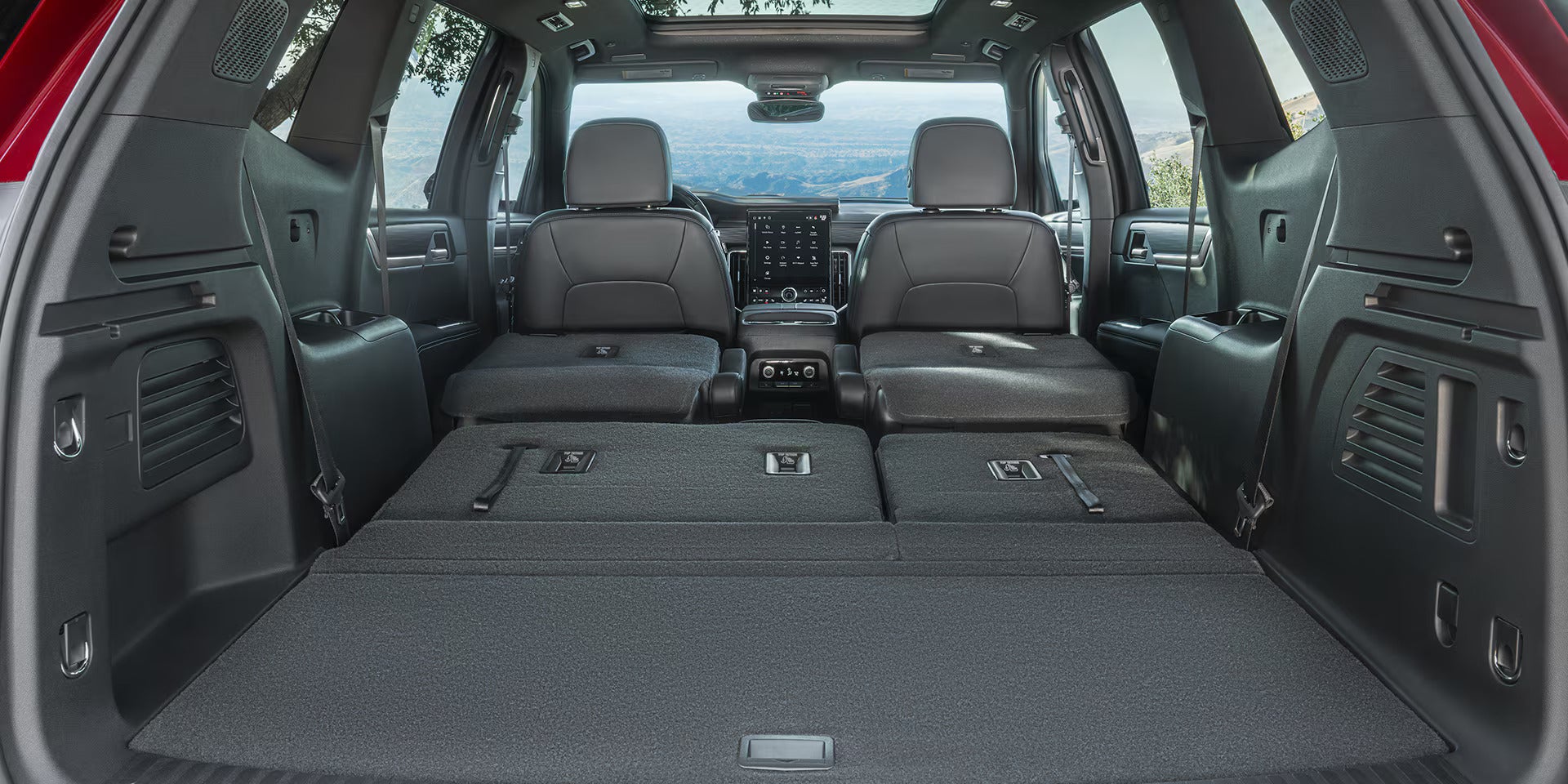 cargo area with 2nd and 3rd row seats down showcasing the massive space in the 2026 gmc acadia
