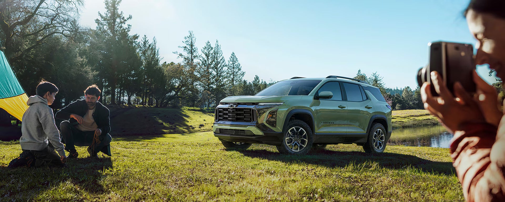 A green suv driving on the road.