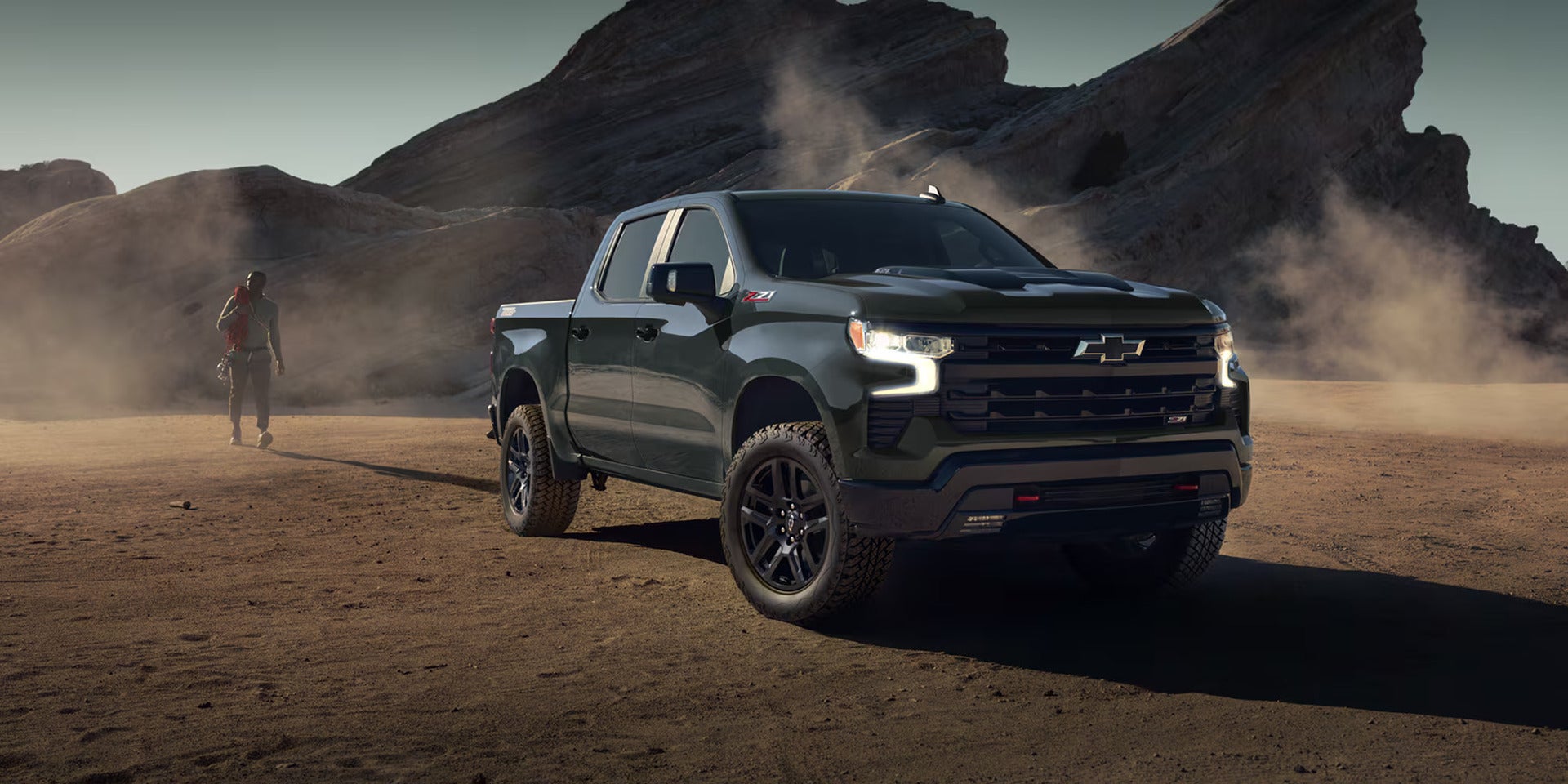 lineup of 2026 chevy silverado 1500s parked overlooking snowcapped mountains