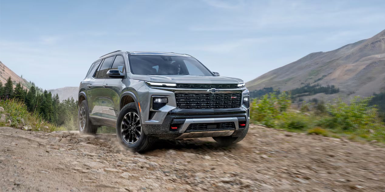 a chevy traverse driving up a rocky path in the mountains