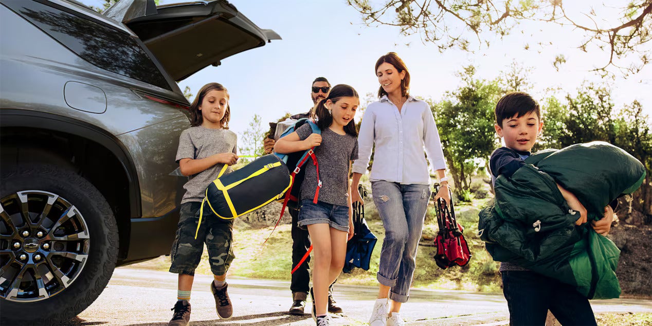 a family getting items out of the back of a chevy traverse about to go hiking