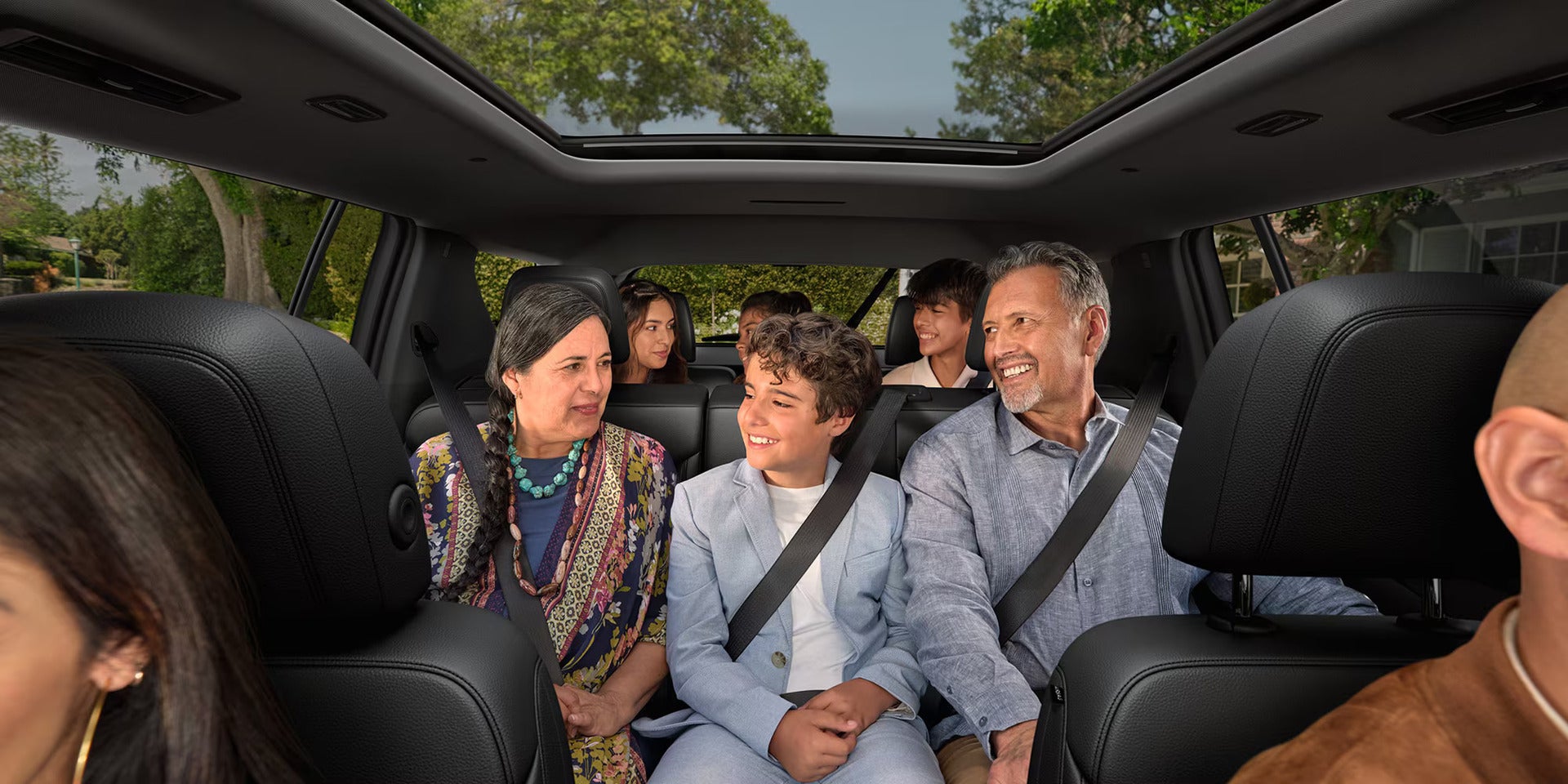 a family sitting inside a chevy traverse with the view of the 2nd and 3rd row