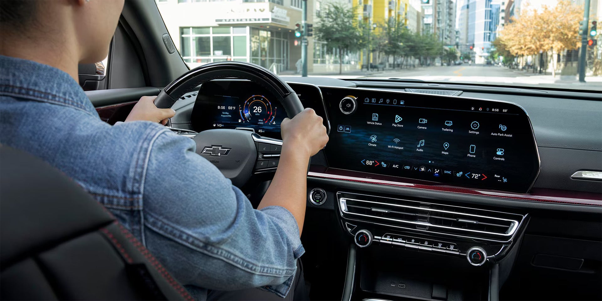 a woman sitting in the drivers seat and driving showcasing the advanced tech in the 2026 chevy traverse