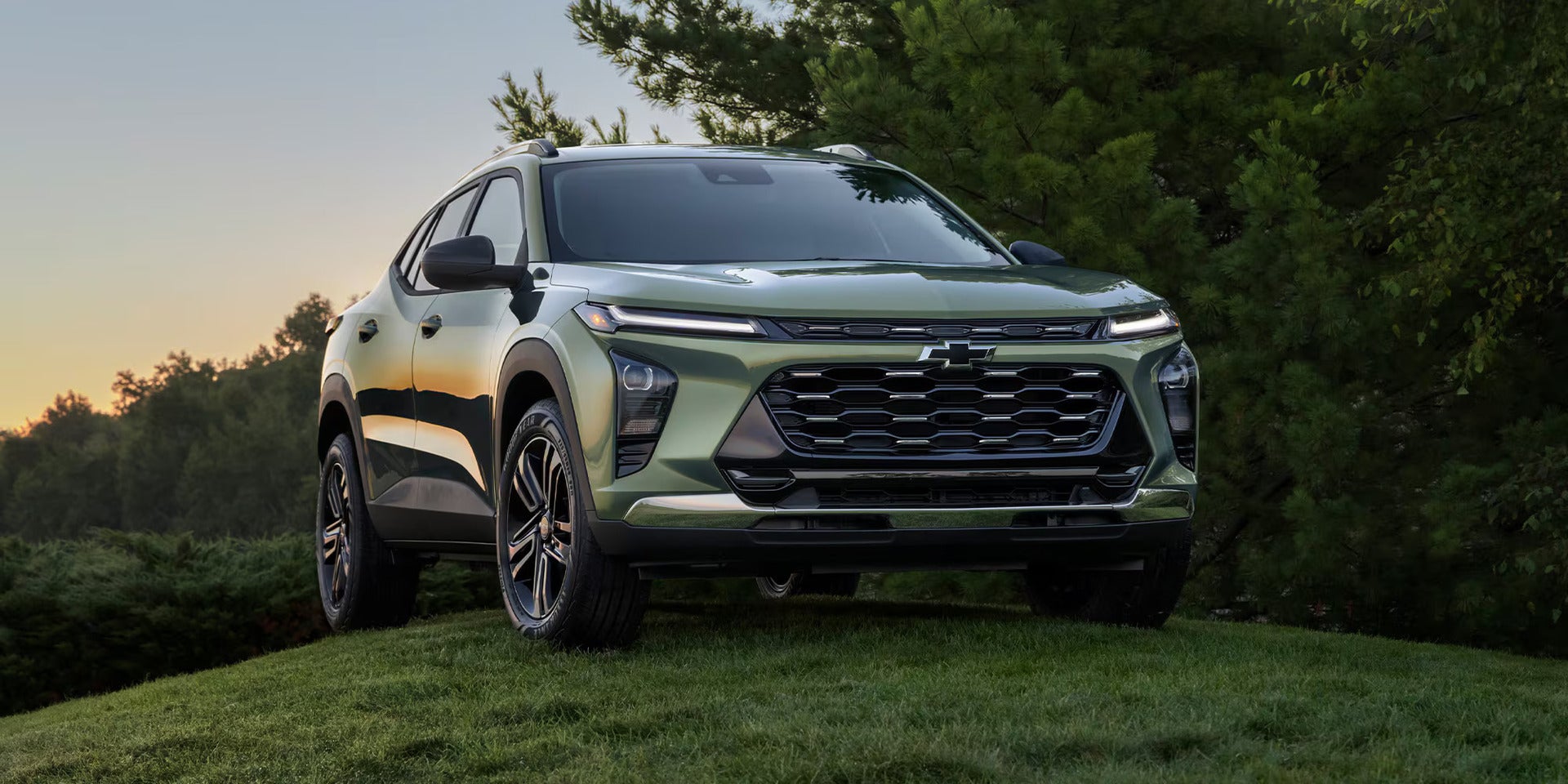 a cacti green 2026 chevy trax parked on a grassy hill