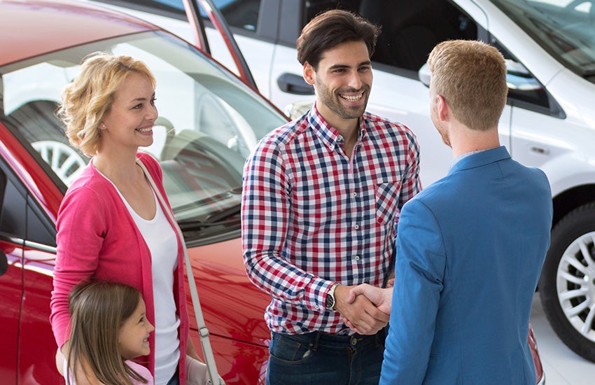 family group of dealership customers ready to buy a vehicle